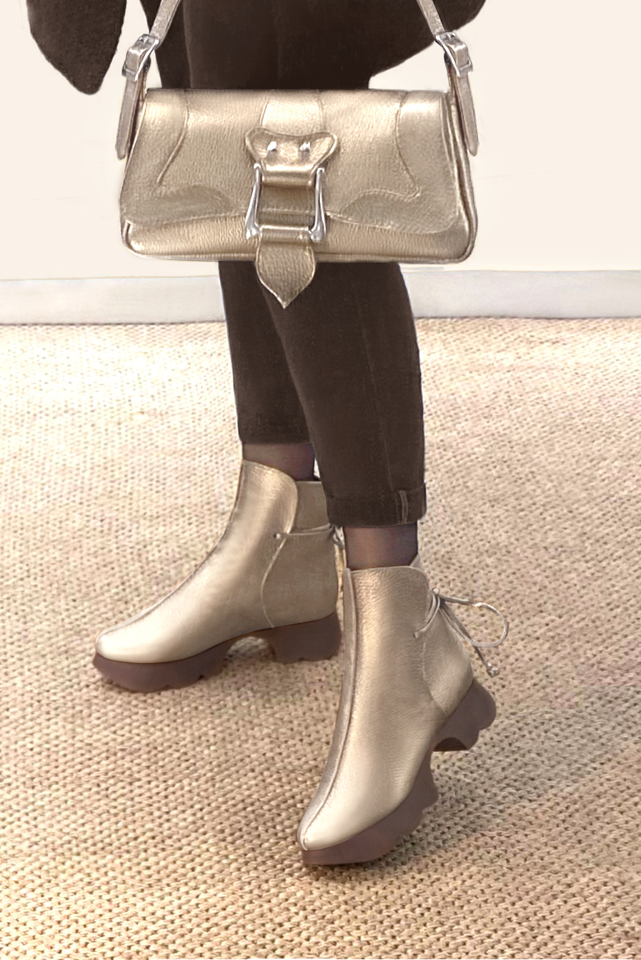 Gold women's ankle boots with laces at the back. Round toe. Low rubber soles. Worn view - Florence KOOIJMAN